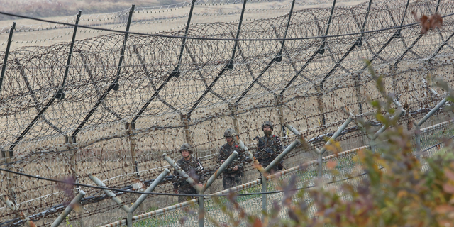 South Korean army soldiers patrol along the barbed-wire fence in Paju, South Korea, near the border with North Korea. (AP Photo/Ahn Young-joon)
