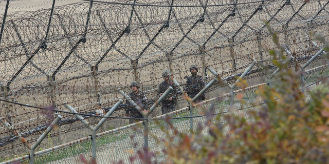 South Korean army soldiers patrol along the barbed-wire fence in Paju, South Korea, near the border with North Korea. (AP Photo/Ahn Young-joon)