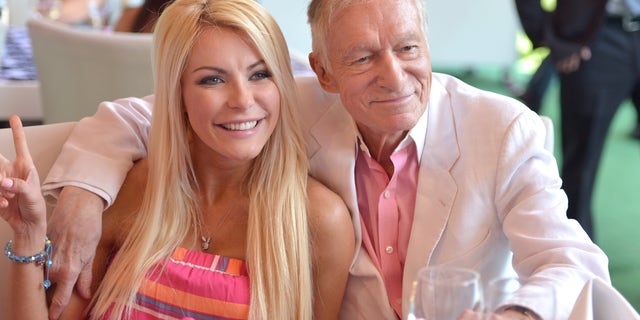 Crystal Hefner, pictured in 2013 with the late Hugh Hefner, shamed the "culture" of today for placing high expectations on women's bodies.