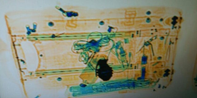 A hand grenade-shaped belt buckle was found inside a woman's suitcase triggering massive disruptions to rail service in Spain. (Mossos d'Esquadra)