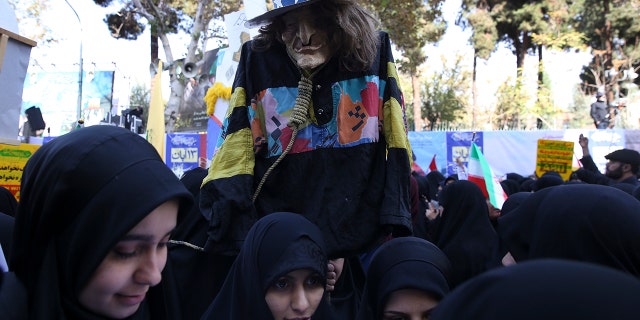 A demonstrator holds an effigy of Uncle Sam during a rally in front of the former U.S. Embassy in Tehran, Iran, on Sunday, marking the 39th anniversary of the seizure of the embassy by militant Iranian students. (AP Photo/Vahid Salemi)