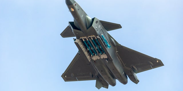 Fighter aircraft J-20 of People's Liberation Army Air Force (PLAAF) performs in the sky showing with live ammunition for the first time on day six of the Airshow China 2018 on November 11, 2018 in Zhuhai, Guangdong Province of China.
