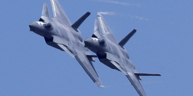 Two J-20 stealth fighter jets of the Chinese People's Liberation Army (PLA) Air Force performs during the 12th China International Aviation and Aerospace Exhibition.