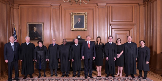 President Trump and Melania Trump pose with members of the Supreme Court, from left to right, retired Justice Anthony M. Kennedy, Associate Justices Neil M. Gorsuch, Sonia Sotomayor, Stephen G. Breyer, Clarence Thomas, Chief Justice John G. Roberts, Jr., Associate Justice Brett M. Kavanaugh, his wife Ashley Kavanaugh, Associate Justices Samuel A. Alito, Jr. and Elena Kagan.