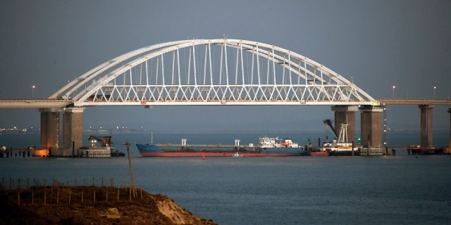 The Kerch bridge is seen blocked for ships entrance, near Kerch, Crimea, Sunday, Nov. 25, 2018. A Russian coast guard vessel rammed a Ukrainian navy tugboat near Crimea, damaging the ship's engines and hull, the Ukrainian navy said Sunday. (AP Photo)