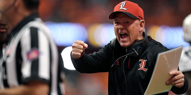Louisville head coach Bobby Petrino tries to get the referees attention during the first half of an NCAA college football game against Syracuse in Syracuse, N.Y., Friday, Nov. 9, 2018. (AP Photo/Adrian Kraus)
