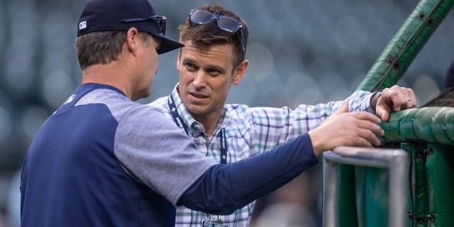 Seattle Mariners general manager Jerry Dipoto (R) talks with manager Scott Servais before a game between the Oakland Athletics and the Seattle Mariners at Safeco Field.