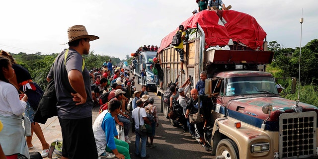 Central American migrants, part of the caravan hoping to reach the U.S. border, get a ride on trucks, in Donaji, Oaxaca state, Mexico, Friday. (AP Photo/Marco Ugarte)