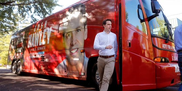Missouri Attorney General and Republican U.S. Senate candidate Josh Hawley steps off his campaign bus to speak to supporters during a stop Tuesday, Oct. 23, 2018, in Ballwin, Mo. Hawley is seeking to unseat Democratic incumbent Sen. Claire McCaskill. (AP Photo/Jeff Roberson)