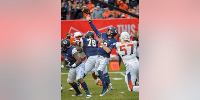 Notre Dame quarterback Ian Book throws a pass during an NCAA college football game against Syracuse.
