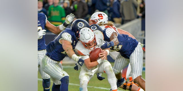 Syracuse quarterback Tommy DeVito is sacked by the Notre Dame defense during an NCAA college football game in New York City, Nov. 17, 2018.