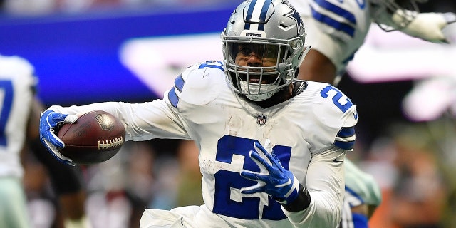 Dallas Cowboys running back Ezekiel Elliott (21) moves past Atlanta Falcons strong safety Damontae Kazee (27) on his way to a touchdown during the second half of an NFL football game, Sunday, Nov. 18, 2018, in Atlanta.
