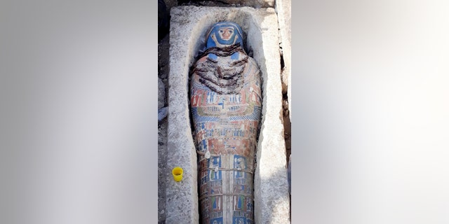 This undated photo released by the Egyptian Ministry of Antiquities on Wednesday, Nov. 28, 2018, shows an ancient mummy covered with a layer of painted cartonnage,
