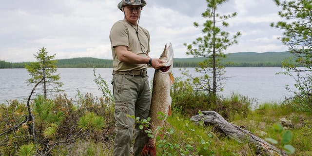 Russia's President Vladimir Putin poses for a picture as he fishes in the Krasnoyarsk territory in the Siberian Federal District July 20, 2013.