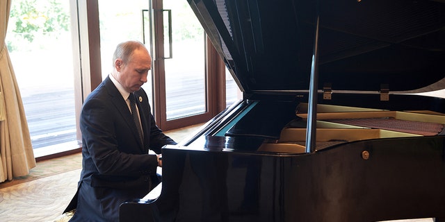 Russian President Vladimir Putin plays piano before his talks with Chinese President Xi Jinping prior to the opening ceremony of the Belt and Road Forum in Beijing, Sunday, May 14, 2017. (Alexei Nikolsky, Sputnik, Kremlin Pool Photo via AP)