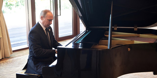 Russian President Vladimir Putin plays piano before his talks with Chinese President Xi Jinping prior to the opening ceremony of the Belt and Road Forum in Beijing, Sunday, May 14, 2017. (Alexei Nikolsky, Sputnik, Kremlin Pool Photo via AP)
