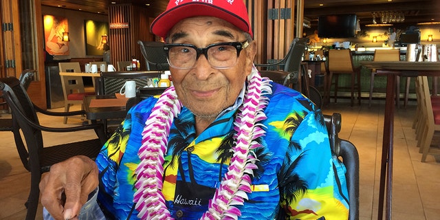 In this Monday, Dec. 5, 2016 photo, Ray Chavez, a Pearl Harbor survivor from Poway, Calif., pauses while eating breakfast in Honolulu. (AP Photo/Audrey McAvoy)
