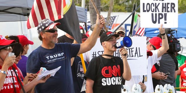 A crowd of protestors gather outside the Broward County of Supervisor of Elections Office as the statewide election recount is underway while ballots for governor, Senate, Agricultural Commission were run through scanning machines in Broward for a second time under the watchful eye of representatives of both parties and the campaigns. (Carl Juste/Miami Herald via AP)