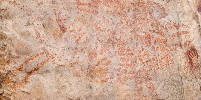 This composite image from the book "Borneo, Memory of the Caves" shows the world's oldest figurative artwork dated to a minimum of 40,000 years, in a limestone cave in the Indonesian part of the island of Borneo.