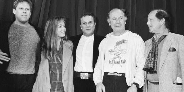 FILE - In this file photo of May 11, 1985, from the left, Gary Busey, Theresa Russell, Tony Curtis, Michael Emil and director Nicolas Roeg perform news at a press conference for