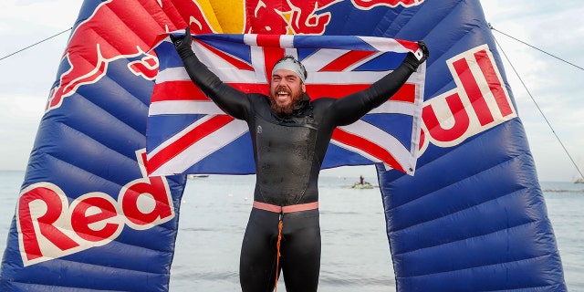 Ross Edgley of England celebrates finishing his 'Great British Swim', a historic nearly 2,000 mile swim around Great Britain. (Photo by Luke Walker/Getty Images for Red Bull)