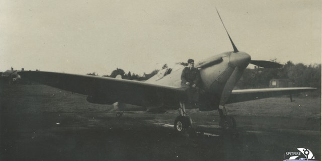 Photo of Flt. Lt. Alastair Gunn sat on a Spitfire. (Spitfire AA810 Project)
