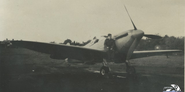 Photo of Flt. Lt. Alastair Gunn sat on a Spitfire.