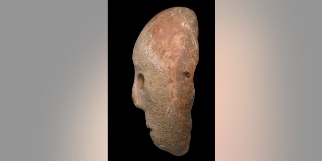 The mask dates back to the Neolithic period. (Clara Amit, Israel Antiquities Authority)