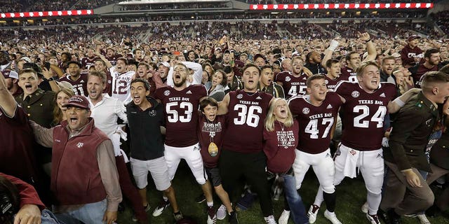 Fans and students join Texas A & M football players in the field after a college football match against the LSU against LSU on Saturday, Nov. 24, 2018, in College Station, Texas. Texas A & M won 74-72 in seven overtime. (Associated Press)
