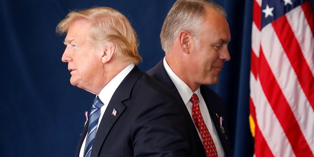 President Trump walks past Interior Secretary Ryan Zinke at a 9/11 observance in Pennsylvania.