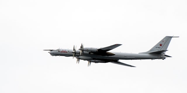 A Russian Tupolev TU-142 flies by the USS Mount Whitney of the US Navy during the NATO-led military exercise Trident Juncture.