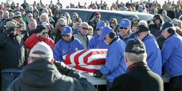 Pallbearers carrying the flag-draped casket of Vietnam veteran Stanley Stoltz at the Omaha National Cemetery on Tuesday. (AP Photo/Nati Harnik)