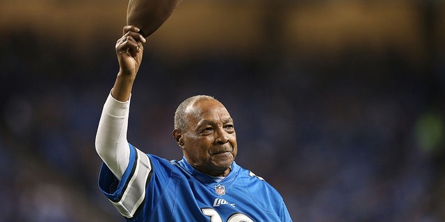 Former Detroit Lions player Wallace "Wally" Triplett waves to the fans during the game against the Baltimore Ravens at Ford Field on December 16, 2013 in Detroit, Michigan.