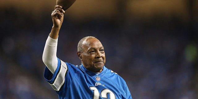 Former Detroit Lions player Wallace "Wally" Triplett waves to the fans during the game against the Baltimore Ravens at Ford Field on December 16, 2013 in Detroit, Michigan.