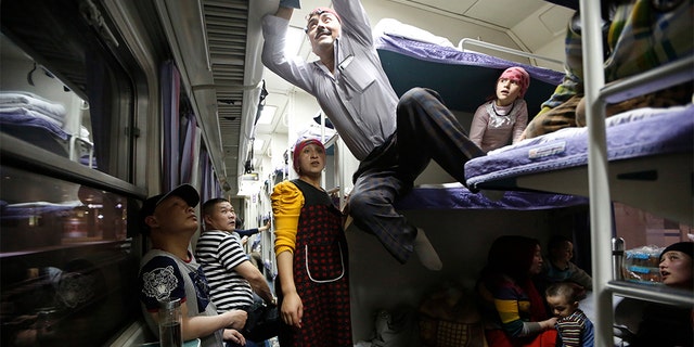A Uighur group traveling on a train to Xingjiang, in Shanghai, May 14, 2014. (REUTERS/Aly Song, File)