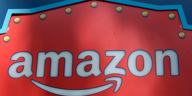 FILE - This Oct. 23, 2018, file photo shows an Amazon logo atop the Amazon Treasure Truck The Park DTLA office complex in downtown Los Angeles. Whether you've bought shoes at Zappos, picked up milk at Whole Foods or listened to an audiobook on Audible, you've been caught up in Amazon's growing web of businesses. And now, Amazon's sprawling empire will stretch even further. The company is expected to announce Tuesday, Nov. 13, that it will open two more bases outside of its Seattle headquarters: one in Crystal City in northern Virginia and the other in New York's Long Island City neighborhood. (AP Photo/Richard Vogel, File)