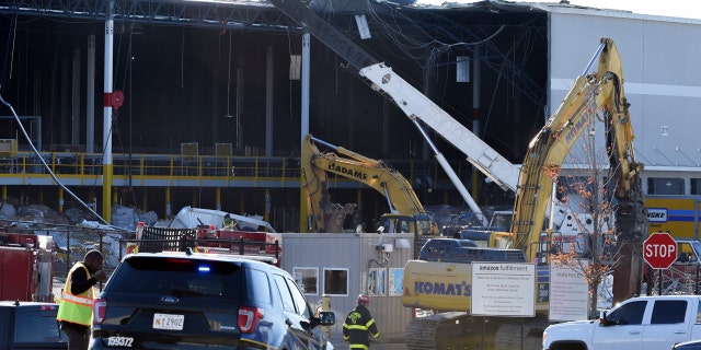 Emergency personnel examine the damage on Saturday, Nov. 3, 2018, following the collapse of a weather-related building at an Amazon distribution warehouse located in southeastern Baltimore on Friday night.