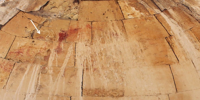 Remnants of the baptism-of-Christ scene (indicated by white arrow) on the apse of the Baptistry chamber. (Photograph by Dror Maayan/Antiquity)