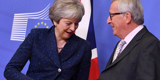 European Commission President Jean-Claude Juncker, right, shakes hands with British Prime Minister Theresa May prior to a meeting at EU headquarters in Brussels, Saturday, Nov. 24, 2018.
