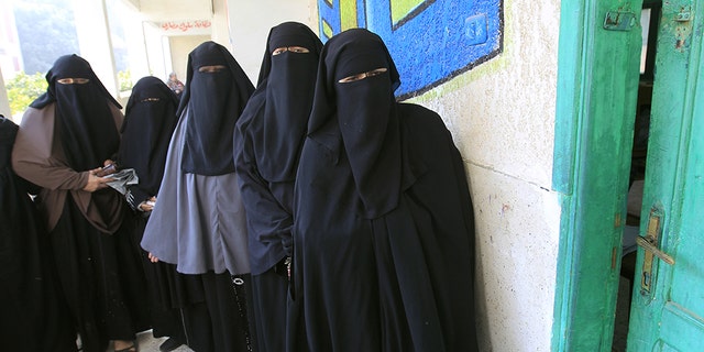 Niqab-clad Egyptian women line up to vote at a polling station in Qaliubia, north of Cairo, on January 4, 2012