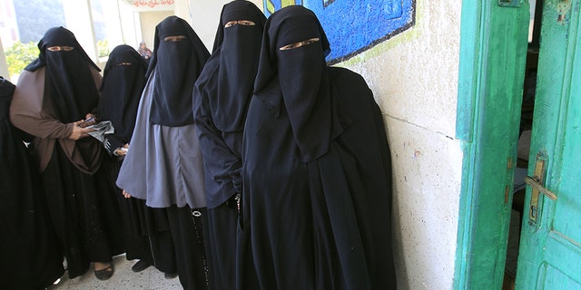Niqab-clad Egyptian women line up to vote at a polling station in Qaliubia, north of Cairo, on January 4, 2012