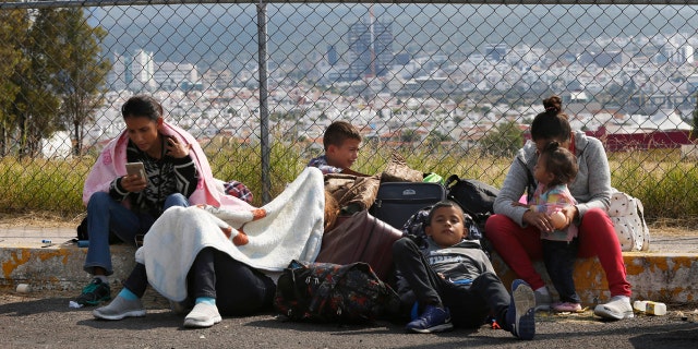 Central American migrants rest outside a soccer stadium after arriving in Queretaro, Mexico, as they resume their journey north.