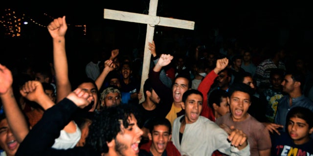 Coptic Christians chant slogans during a protest following an attack on a bus carrying Christian pilgrims on their way to a remote desert monastery, in Minya, Egypt, Friday, Nov. 2, 2018.