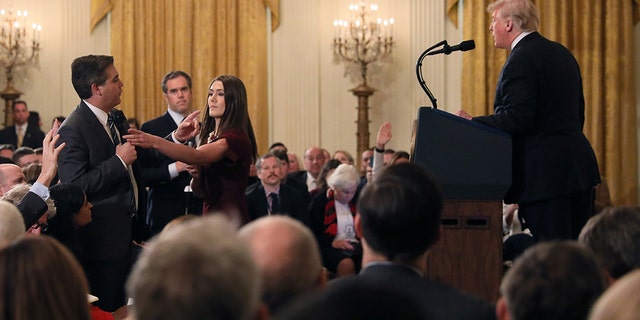 CNN's Jim Acosta refuses to give up the microphone as he questions President Donald Trump during his news conference at the White House Nov. 7, 2018. (Reuters/Jonathan Ernst)