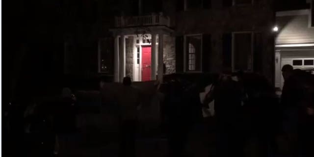 Activists chanted threats outside Fox News' Tucker Carlson's home Wednesday evening.