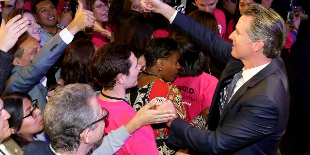 Lt. Gov Gavin Newsom shakes hands with an election night crowd after he defeated Republican John Cox to become 40th governor of California, Tuesday, Nov. 6, 2018, in Los Angeles. (AP Photo/Rich Pedroncelli)