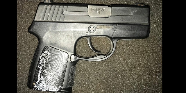 A woman was caught trying to carry a 9mm handgun with the Statue of Liberty on it through security at an airport in Virginia.