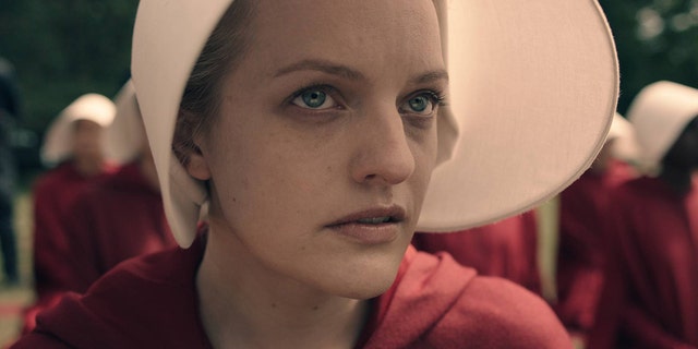 Elisabeth Moss plays the role of Offred in Hulu's "The Handmaid's Tale" based on Margaret Atwood's book.