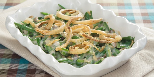 Green bean casserole is a traditional Thanksgiving side dish. The veggie is usually mixed with cream of mushroom soup and french-fried onions.