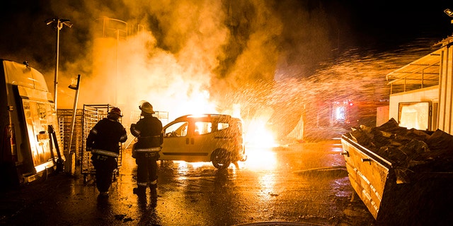 Israeli firefighters work at the scene where a rocket fired from the Gaza Strip hit in Sderot, Israel, on Monday.